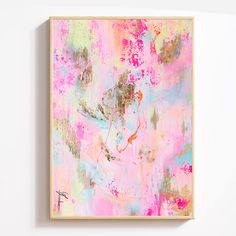 a painting hanging on the wall with paint splattered all over it's surface