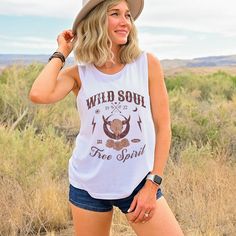 Get ready to be OBSESSED with your new 'Wild Soul Free Spirit' vintage cowgirl t-shirt. It's the cutest and most trendy way to emit all those important Boho Western vibes! This is the perfect tee for Boho cowgirls, country western lovers, rodeo shows, country festivals or road trips and makes a great gift for trendy Western clothing/Fashion lovers! Please note: We have intentionally added a distressed effect to your tshirt, to give it a more aged/retro look. Have a look around my shop to see wha Fitted Graphic Print Tops For Western-themed Events, Bohemian Graphic Print Rodeo Top, Bohemian Graphic Print Tops For Rodeo, Western Cotton Tops For Country Festivals, Western Style Fitted Cotton Tops, Cotton Tops For Country Concerts And Festivals, Western-style Cotton Top For Western-themed Events, Western Style Tops For Country Concerts And Festivals, Western Style Cotton Top For Western-themed Events