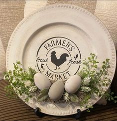 a white plate topped with eggs and greenery