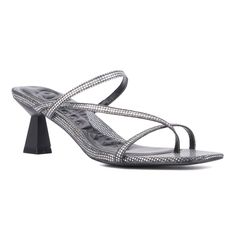 A square toe silhouette gets a stylish update with the Angelic sandal. Designed with asymmetrical straps, it adds a touch of edginess to your wardrobe. The slide silhouette ensures ease of wear, making it perfect for warmer weather. This versatile sandal seamlessly transitions from day to night, offering both comfort and style. Elevate your look effortlessly with the Angelic, a must-have addition to your summer footwear collection that combines modern design with practicality. Modern Square Toe Sandals For Night Out, Glamorous Black Sandals With Single Toe Strap, Trendy Evening Sandals With Single Toe Strap, Trendy Evening Toe Post Sandals, Fitted Toe Post Sandals For Evening, Glamorous Evening Sandals With Square Toe, Trendy Square Toe Sandals For Night Out, Modern Square Toe Sandals For Party, Sleek Square Toe Party Sandals