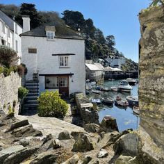 boats are parked in the water next to houses and buildings on the shore with stairs leading up to them