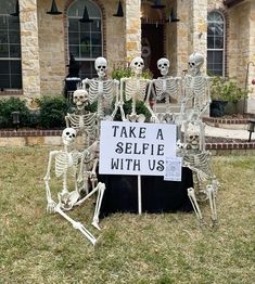 there is a sign that says take a selfie with us in front of some skeletons