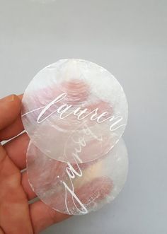 a person holding three small round candies in their hand with the word fearless written on them