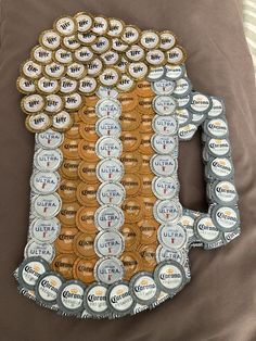 a beer bottle made out of coins on top of a bed