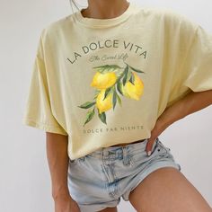 Our Comfort Colors® t-shirt, featuring "La Dolce Vita" with a vibrant lemons graphic, is a perfect blend of Italian charm and preppy style. Ideal for an Italy vacation or adding a citrusy touch to your wardrobe, this lemon shirt captures the essence of Italia and the refreshing spirit of limoncello. Prefer this design on a Sweatshirt? Visit this link: https://bohemianbloomdesigns.etsy.com/listing/1775765095 Prefer this design on a Baby Tee? Visit this link: https://bohemianbloomdesigns.etsy.com/ Yellow Funny Print Crew Neck Top, Yellow Funny Print Top For Summer, Yellow Short Sleeve Top With Letter Print, Trendy Printed Yellow Shirt, Trendy Yellow Printed Shirt, Yellow Printed Crew Neck Shirt, Casual Short Sleeve Shirt With Funny Print, Yellow Shirt With Funny Print In Relaxed Fit, Yellow Shirt With Funny Print And Relaxed Fit