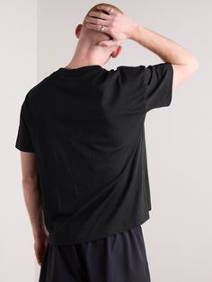 Fear of God Essentials' T-shirt is cut from cotton-blend jersey and branded with the label's logo at the nape. As the line's name suggests, it's designed for comfort and frequent wear. The neck sits slightly higher than standard styles, so it works well layered. Black Jersey T-shirt With Logo Print, Cotton Crew Neck Muscle Tee For Athleisure, Graphic Print Solid Color Tops For Streetwear, Graphic Print Tops For Streetwear, Solid Color Graphic Print Tops For Streetwear, Solid Color Tops With Graphic Print For Streetwear, Relaxed Fit Cropped Cotton T-shirt For Sports, Sports Cotton T-shirt With Back Print, Sports T-shirt With Back Print And Crew Neck