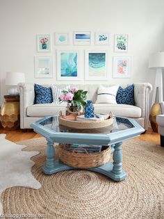 a living room filled with furniture and pictures on the wall above it's coffee table