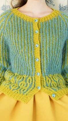 a close up of a woman wearing a sweater with buttons on the front and back