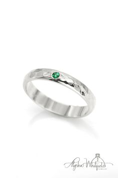 A simple emerald wedding band design with a luxurious hammered finish.  Natural gemstone in Palladium White Gold. Thick Band Diamond Cut Ring For Promise, Green Ring With Single Diamond In Fine Jewelry Style, Green Diamond Ring In Fine Jewelry Style, Emerald Ring With Single Diamond For Anniversary, Sterling Silver Promise Ring With Thick Band, White Gold Jewelry With Thick Band For Promise, Promise Stackable Rings With Single Diamond On Round Band, Green Wedding Ring With Single Diamond, Promise Stackable Rings With Single Diamond