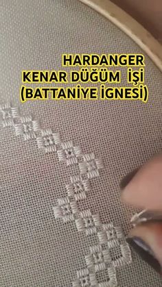 someone is working on a cross stitch project with the words, hadanger kenar dugum is battanye ignes