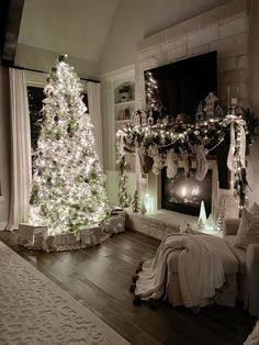 a living room decorated for christmas with a lit tree in the corner and presents on the mantle