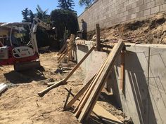 construction workers are working on the side of a building that's being built with wooden planks