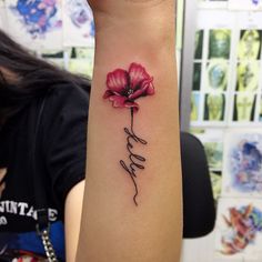 a woman's arm with a flower tattoo on the left side of her arm