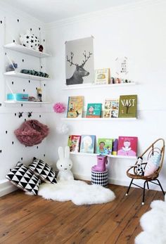 a child's room with white walls and wooden floors