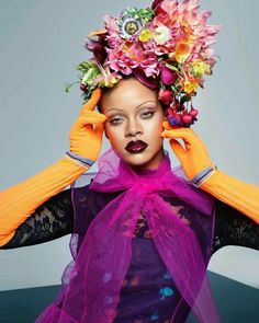 a woman with flowers in her hair and gloves on top of her head, posing for the camera