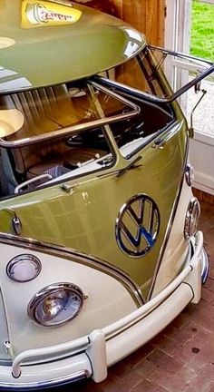 an old vw bus with a surfboard on top