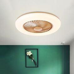 a bathroom with green walls and a round light fixture above the bathtub in the corner