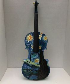 the violin is painted with van gogh style paintings on it's body and neck