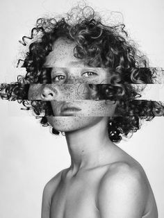 a woman with curly hair and freckles on her face is shown in black and white