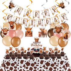 an animal themed birthday party set up with balloons, streamers and cow heads on the table