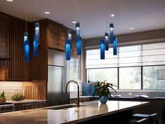 a modern kitchen with blue lights hanging from the ceiling