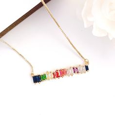 "Rainbow Bar Necklace, Rainbow Necklace, Rainbow Jewel Stones Necklace, Gold Rainbow Necklace, Gold Bar Necklace Rainbow Bar Necklace necklace with brilliant Cubic Zirconia stone Box chain necklace length adjustable to 16+2\" extender The clasp is 14K GOLD FILLED All items come wrapped individually in a ribboned gift box. Thank you for looking." Stones Necklace Gold, Jewel Stones, Rainbow Bar, Mothers Day Gift Ideas, Stones Necklace, Rainbow Necklace, Gold Bar Necklace, Round Necklace, Necklace Chain Lengths