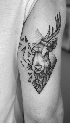 a man with a deer head tattoo on his arm