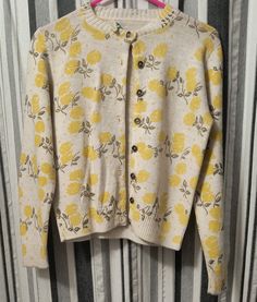 100% Orlon Acrylic and 100% Adorable Yellow Floral Print Sweater.  22"sleeve 16.5 across shoulders 15" bust 22" length Size is Small-Medium Brand is May Knit Classic Yellow Sweater For Spring, Retro Crew Neck Cardigan For Fall, Fitted Sweater For Daywear In Winter, Vintage Fitted Crew Neck Outerwear, Fitted Vintage Outerwear With Crew Neck, Fitted Cream Sweater For Daywear, Vintage Spring Sweater With Buttons, Retro Cream Sweater For Spring, Spring Daywear Crew Neck Sweater