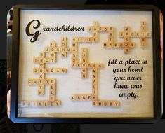 a scrabble frame with words written on it in black and white, which include the names of people