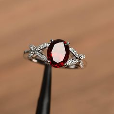 It is natural garnet ring. The main stone is 7 mm*9 mm oval cut.weight about 2.33 carats. The basic metal is sterling silver and plated with rhodium. To change the metal to a solid gold (white/rose) or platinum is also available, please ask for a quotation if you want. You can also go to my shop Home for more elegant rings: https://www.etsy.com/shop/godjewelry?ref=hdr_shop_menu garnet is January birthstone . More garnet rings: https://www.etsy.com/shop/godjewelry?section_id=20709242 Customizatio Gothic Ruby Rings, Demantoid Garnet Ring Engagement, Red Crystal Engagement Ring, Witchy Wedding Rings Ruby, Unique Engagement Rings Silver Ruby, Red Wedding Rings Women, Avengers Engagement Rings, Red Engagement Ring Zales, Deep Red Rings