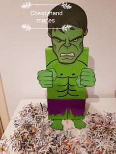 an image of a paper cut out of a hulk character surrounded by shredded up confetti