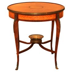 an antique wooden table with a basket on it