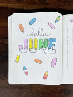 an open notebook with the words hello june written in colorful crayons on it