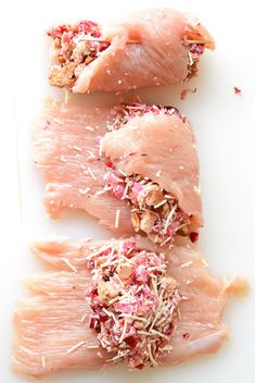 three raw fish fillets on a white surface