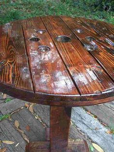 an old wooden table with some glass knobs on it's top and bottom