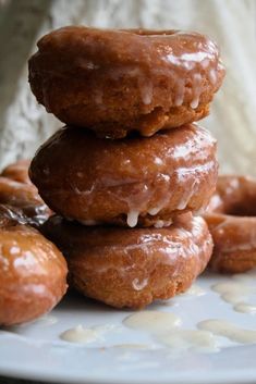 a stack of doughnuts sitting on top of a white plate