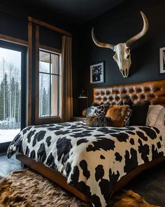 a cow skull mounted to the side of a wall above a bed in a bedroom