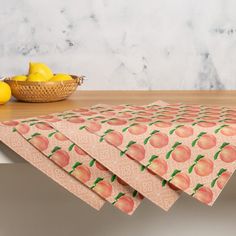 four pieces of paper with peaches and lemons on them next to a basket of lemons