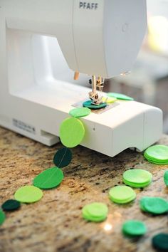 a sewing machine with green buttons on it