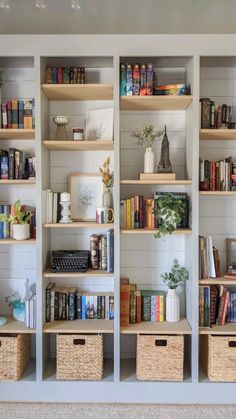 the bookshelves are filled with many different types of books and vases on them