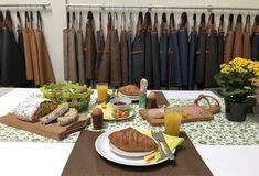 the table is set with bread, fruit and juice