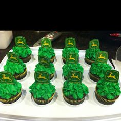 cupcakes decorated with green frosting on a tray