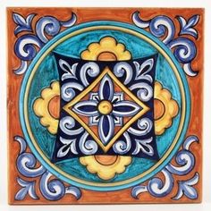 an artistic tile with blue, yellow and orange designs on the outside of its center