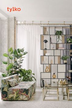 a living room filled with furniture and lots of plants