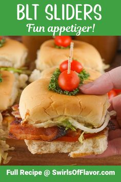 a hand holding a bacon and lettuce slider with tomatoes on the top