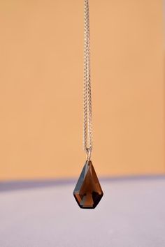 A bold and impactful pendent with classic facet cuts in smokey gemstone. No matter how you style it, you can guarantee that it will be a statement piece.  Gemstone - Smokey Quartz Shape - Fancy  Size - Free Size Chain - 925 Sterling Silver Smoky Quartz Necklace, Smoky Quartz Pendant, Rose Quartz Ring, Birthstone Pendant, June Birthstone, Quartz Ring, Smokey Quartz, Quartz Necklace, June Birth Stone