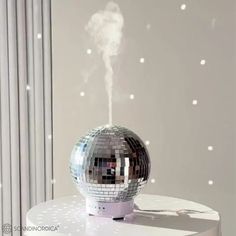 a silver disco ball sitting on top of a white table