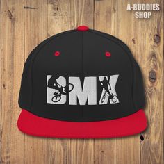 a black and red hat with the word bmx on it