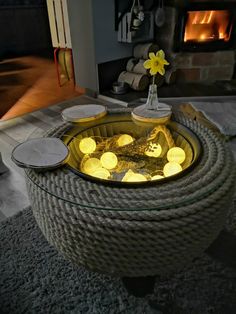 a living room with a fire place in the center and some candles on top of it