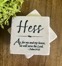 a coaster with a bible verse on it sitting next to some green plants and a potted plant